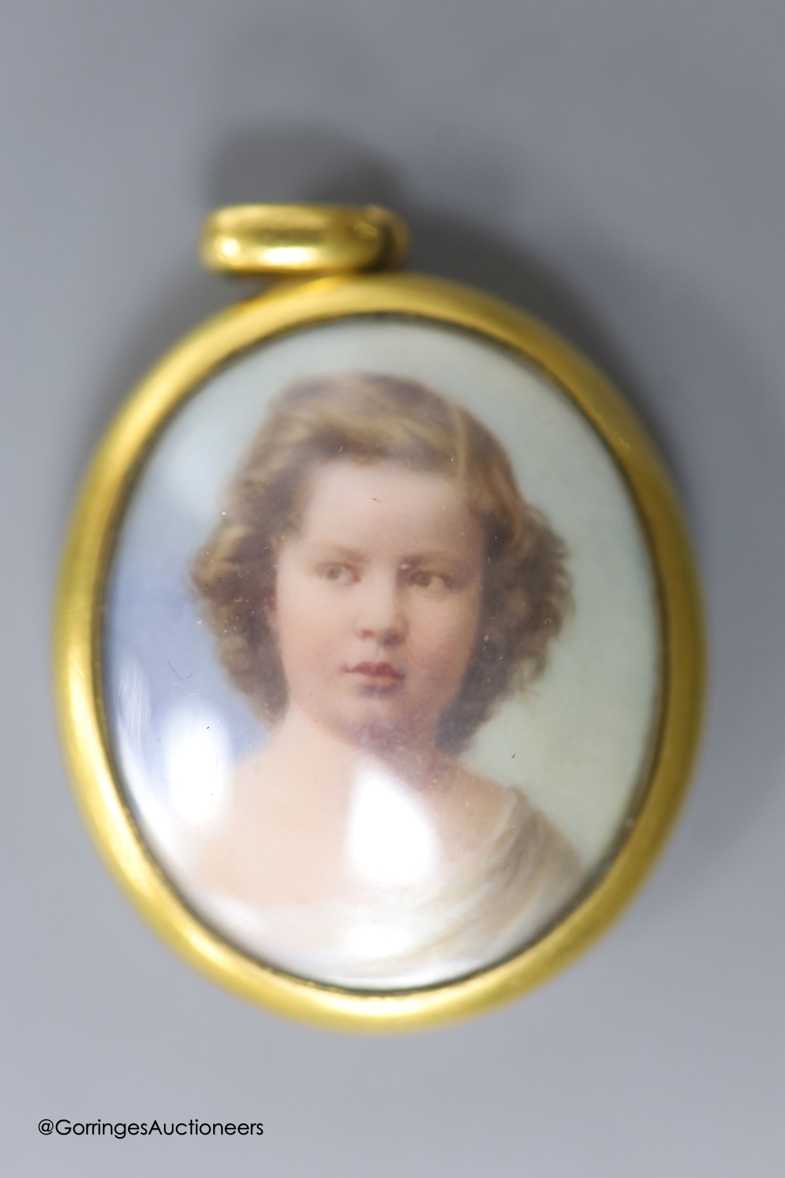 A Victorian yellow metal mounted glazed oval pendant, with miniature portrait of a young lady and plaited hair verso, 40mm, gross weight 18.1 grams, a yellow metal and tooth mounted stick pin and a gem set white metal cl